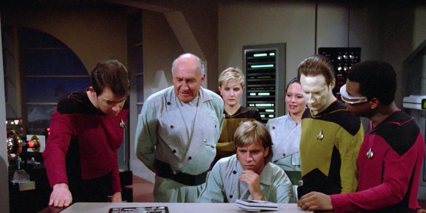 Various scientists and crew members inspect a crystal being from Star Trek The Next Generation