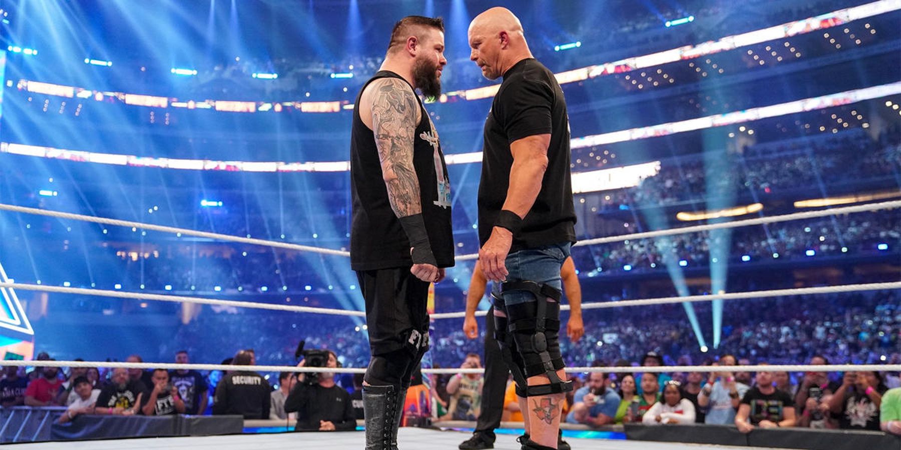 Stone Cold Steve Austin and Kevin Owens stare each other down before getting physical at WWE WrestleMania 38.