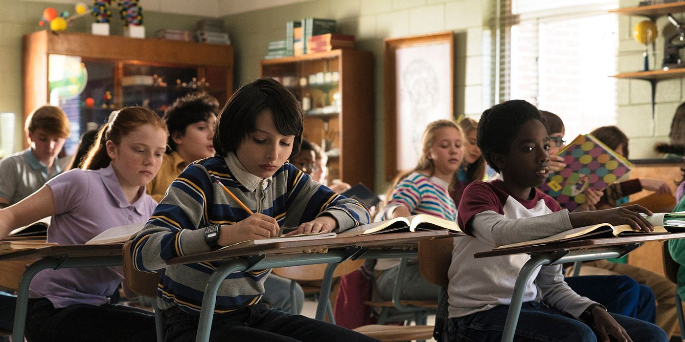 Mike and Lucas sitting in class on Stranger Things.