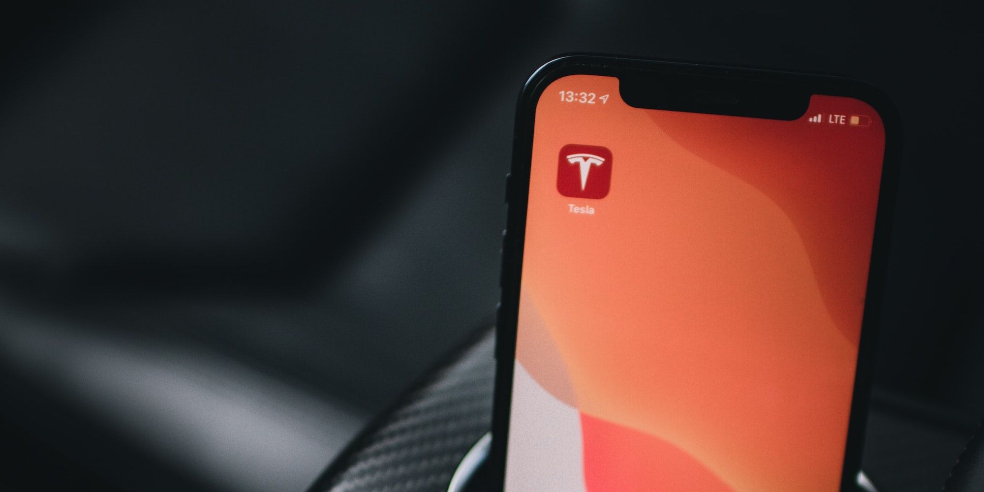 The Tesla app icon on an iPhone screen