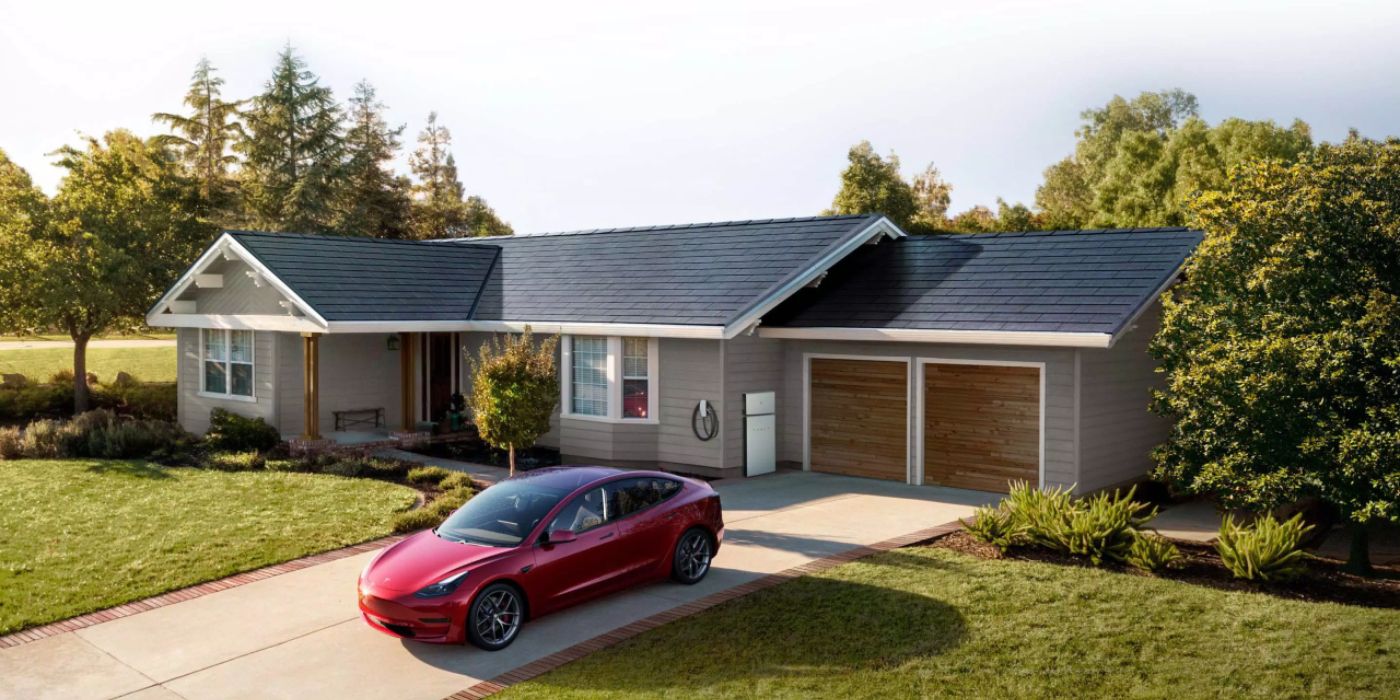 Tesla EV parked outside a house with a Powerwall in the background