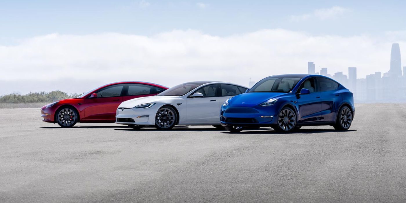 Três Tesla EVs (em vermelho, branco e azul) estacionados próximos um do outro