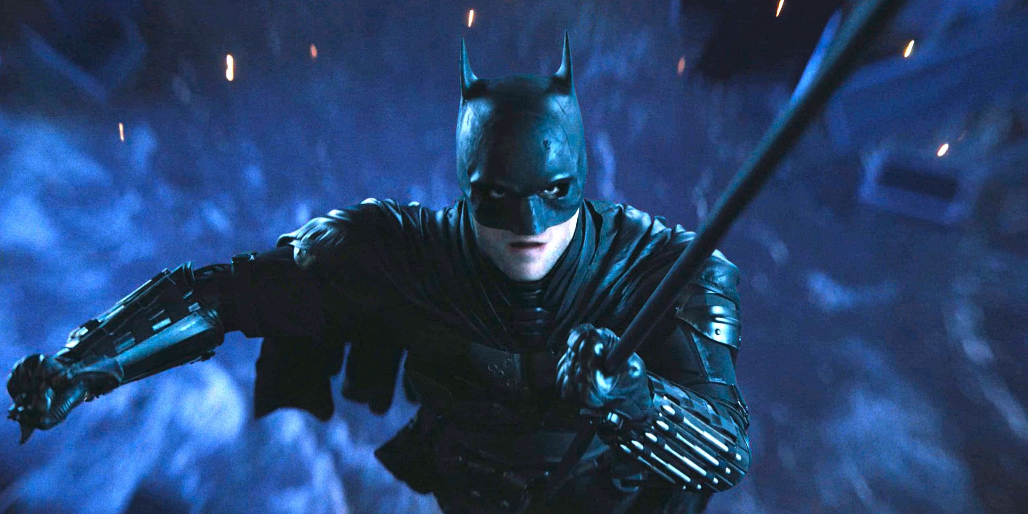 The Batman 2022 Robert Pattinson como Batman voando pelo ar em seu gancho