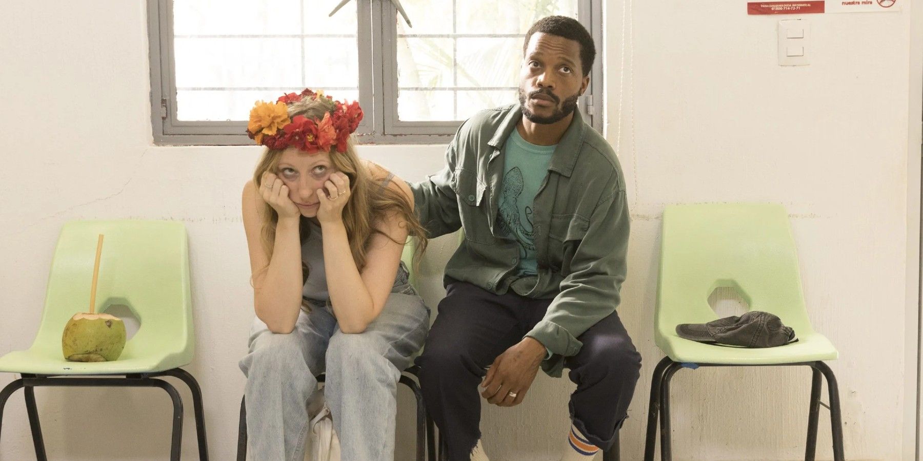 A man and woman sitting in chairs looking sad in The Drop