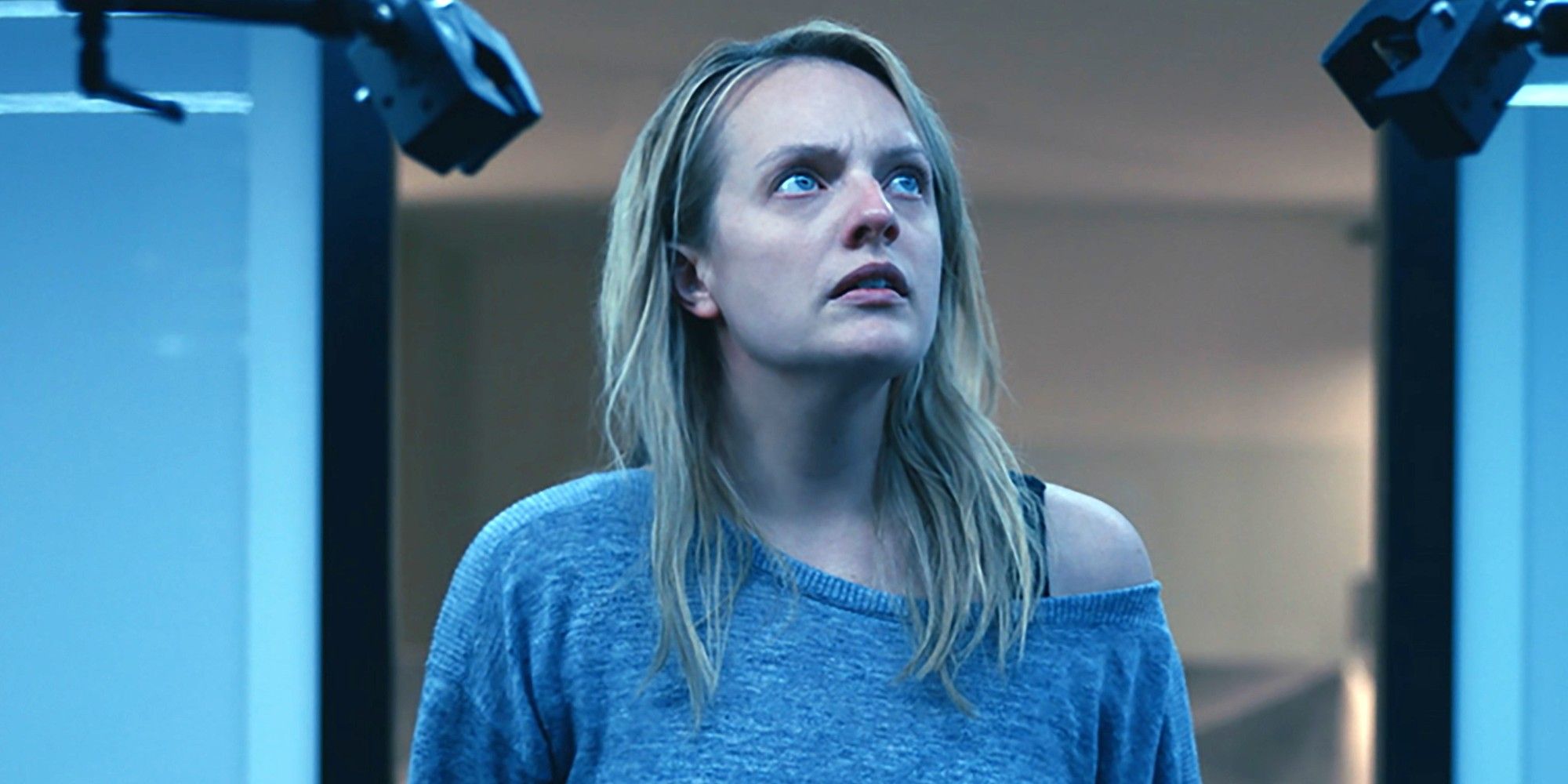 Elisabeth Moss looking off-camera in fear in The Invisible Man.