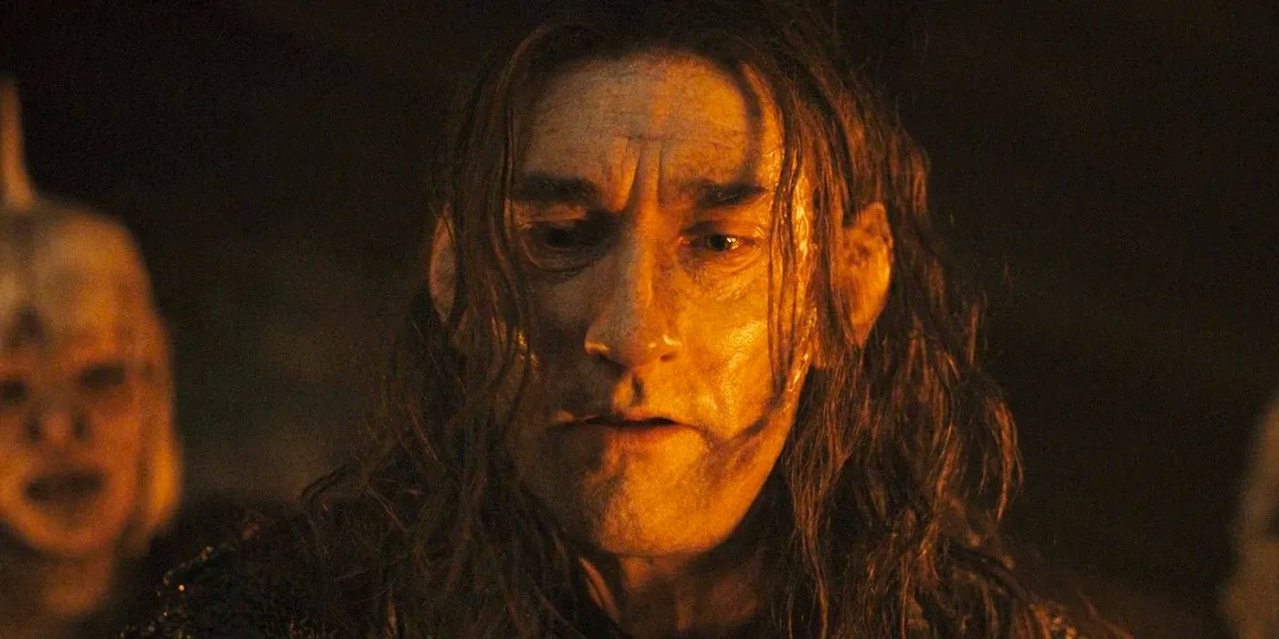 Joseph Mawle pondering something as Adar in The Lord of the Rings: The Rings of Power.