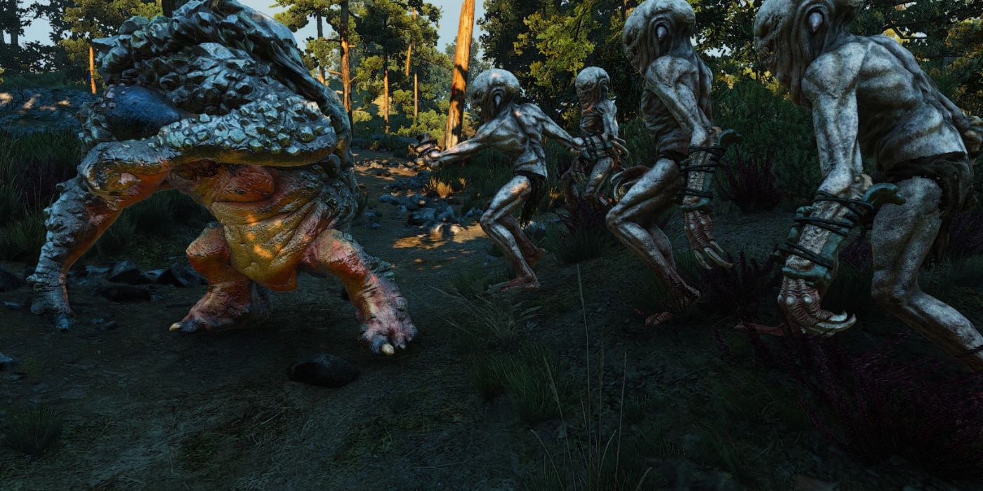 Um grupo de nekkers assediando um troll do rock em The Witcher 3.
