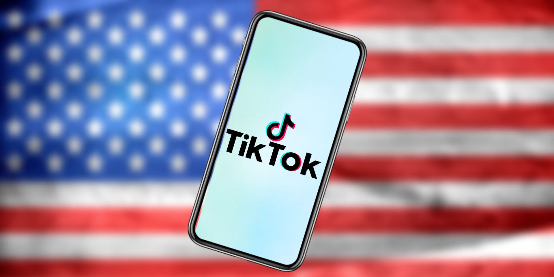 TikTok logo on a smartphone in the foreground with a blurred American flag in the background