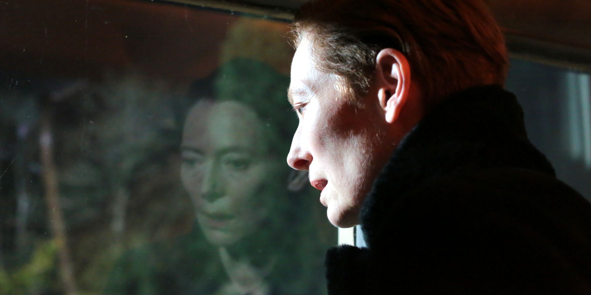 Tilda Swinton as Julie reflected in a window in The Eternal Daughter