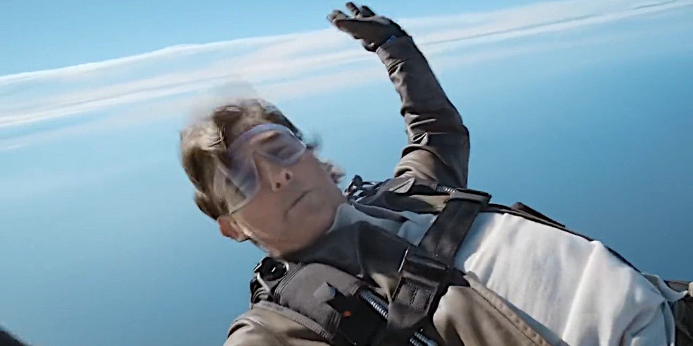 Tom Cruise wearing a parachute while skydiving over the ocean as part of a movie stunt