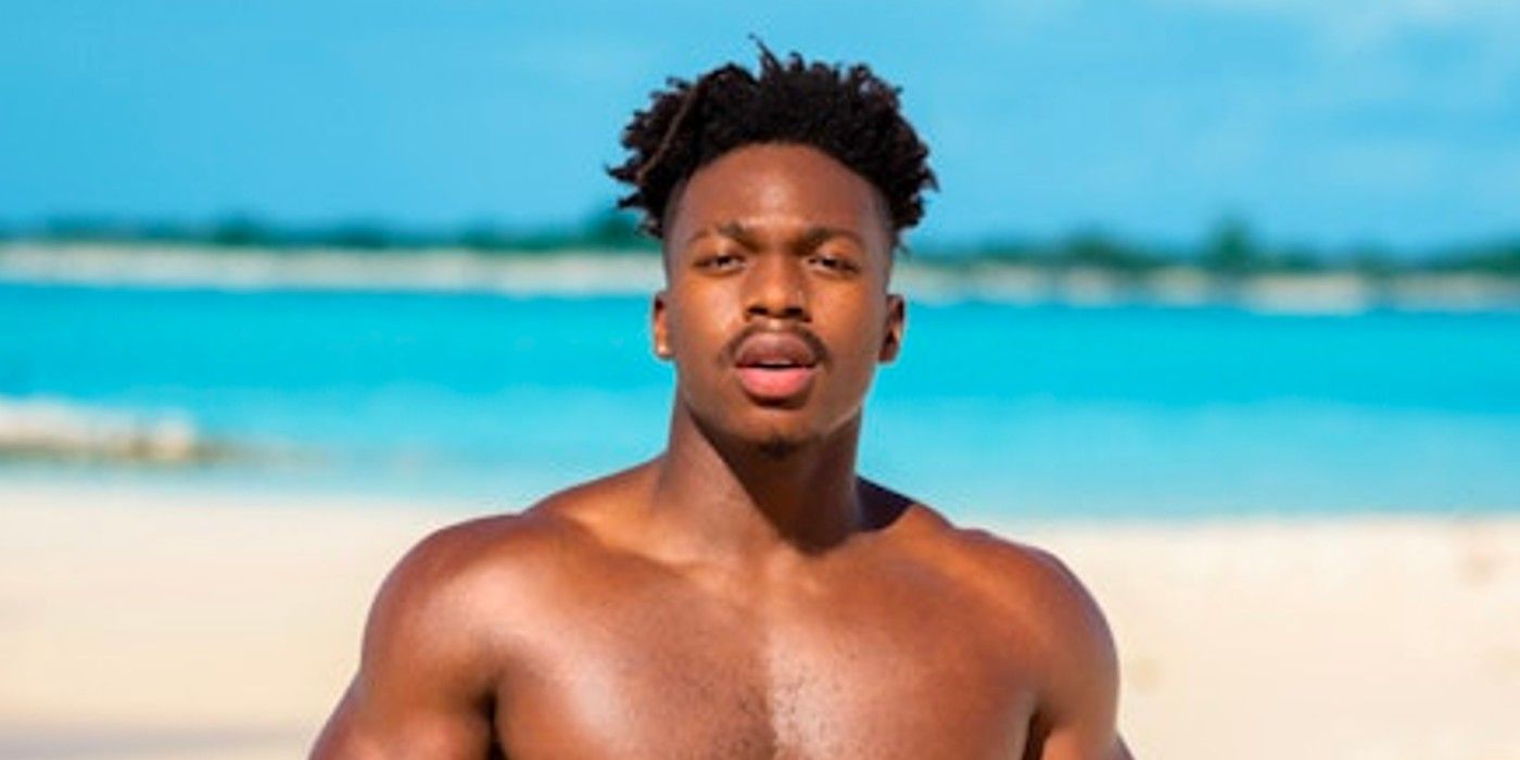 Too Hot To Handle Season 4's James Pendergrass shirtless on a beach looking serious.