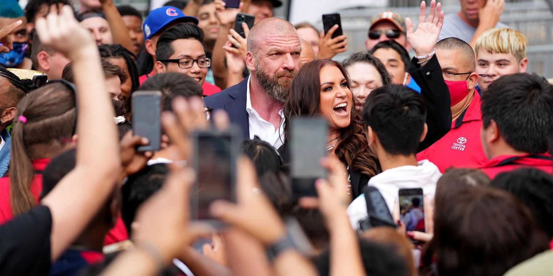 Triple H and Stephanie McMahon are greeted by a throng of WWE fans in 2022.