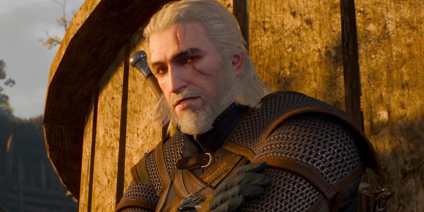 Geralt de The Witcher 3 com os braços cruzados, encostado em uma parede de madeira.