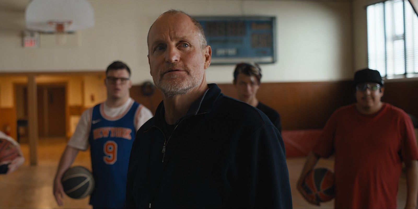 Woody Harrelson coaching on the basketball court in Champions