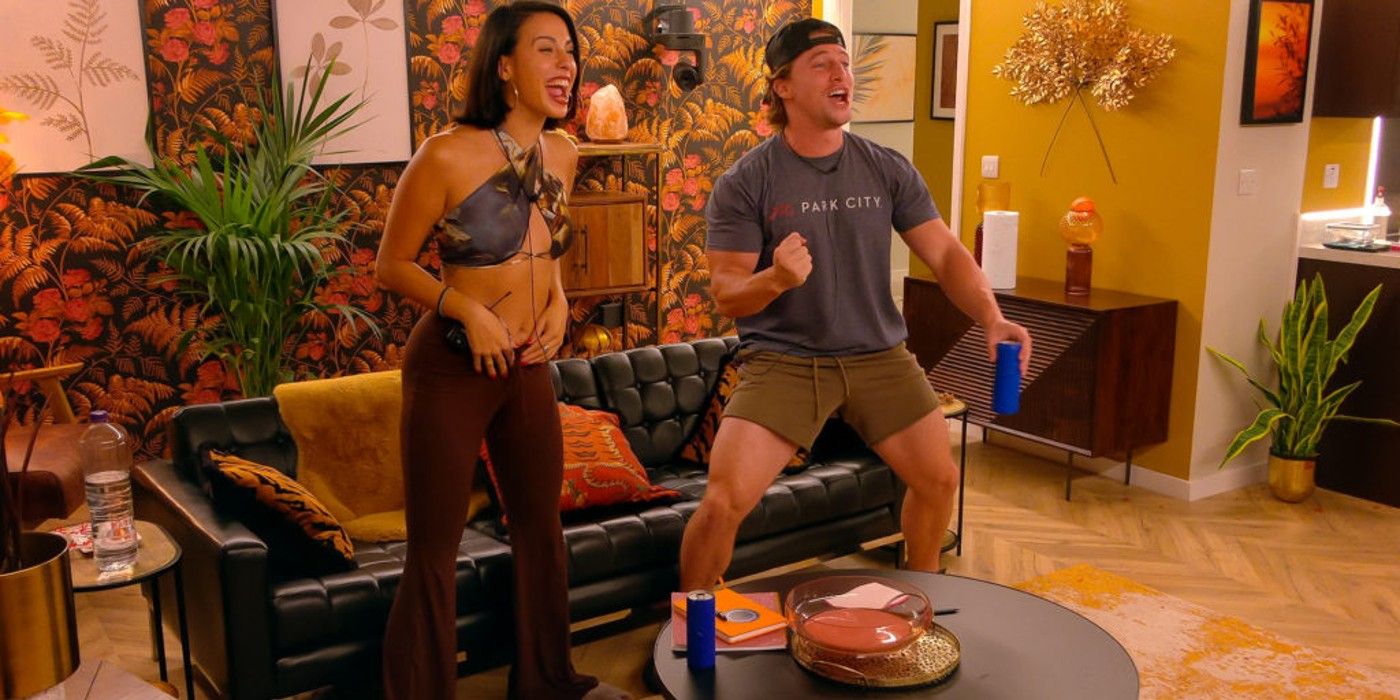 xanthi and brett from the circle season 5 standing up and celebrating in their apartment