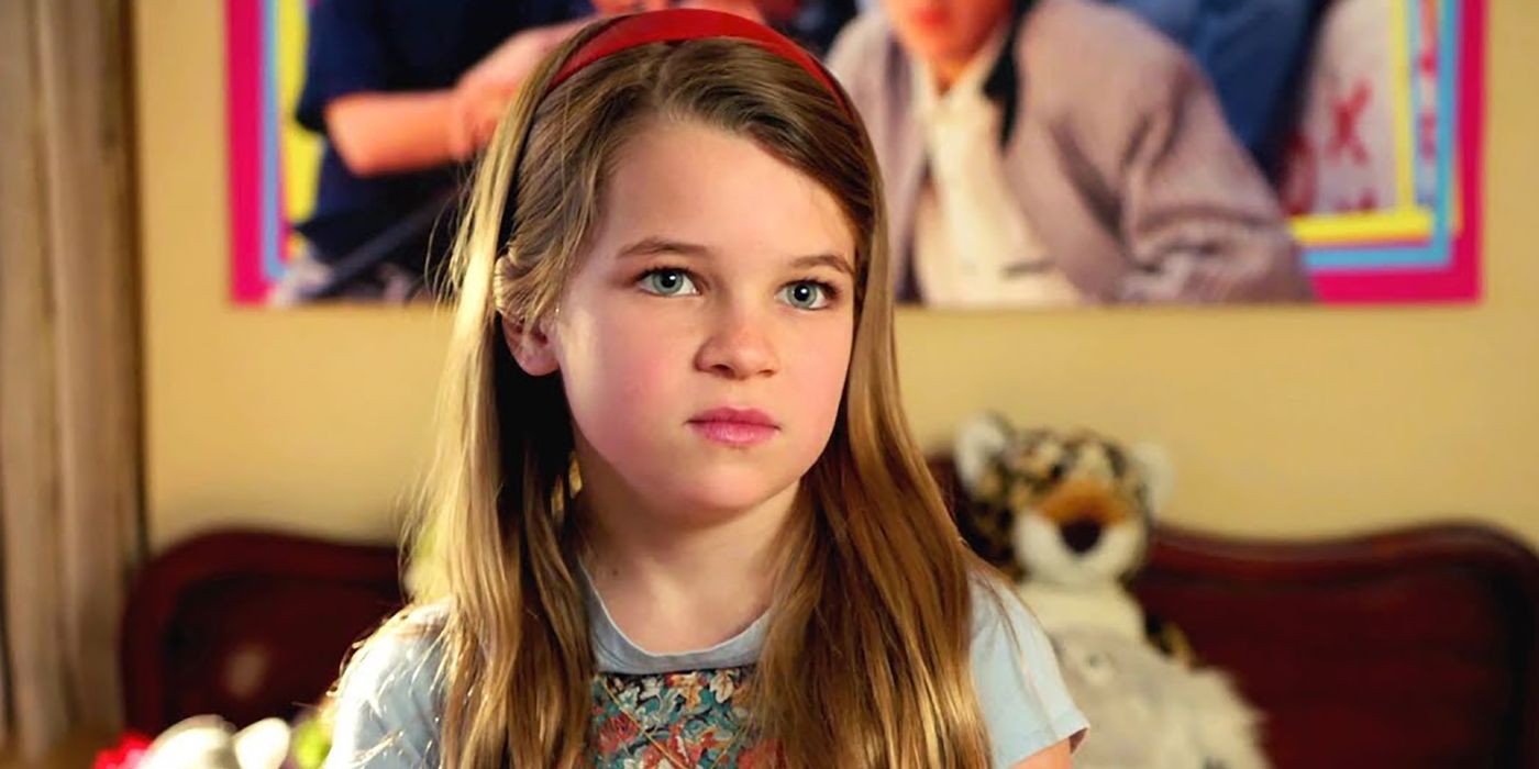 Uma jovem Missy de Young Sheldon sentada em sua cama.