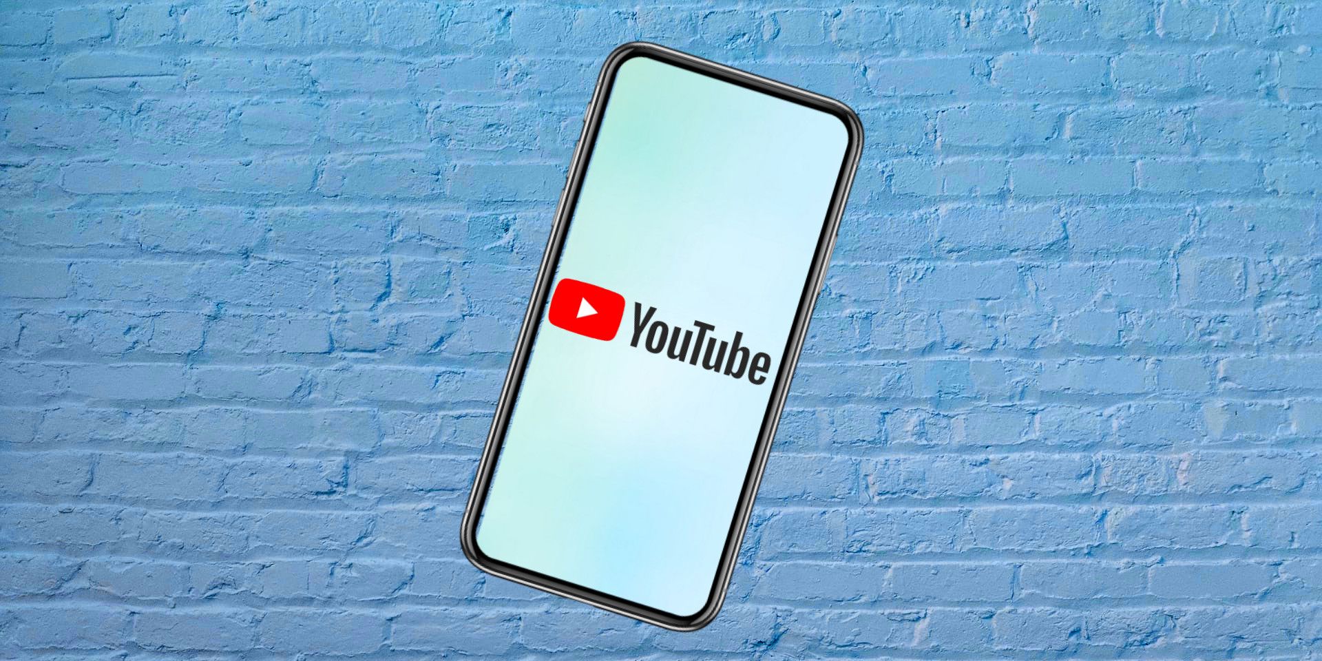 YouTube logo on smartphone with a custom brick background