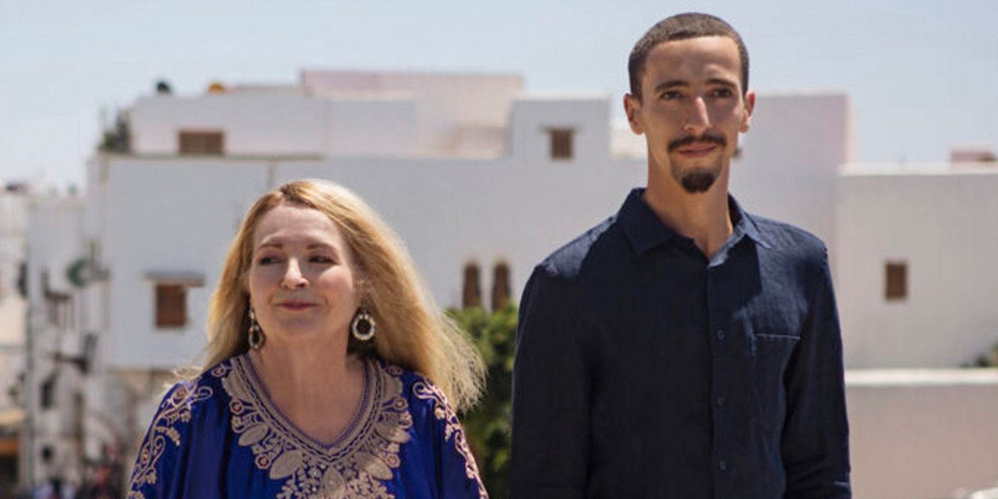 90 Day Fiancé couple Debbie & Oussama standing outside in front of buildings