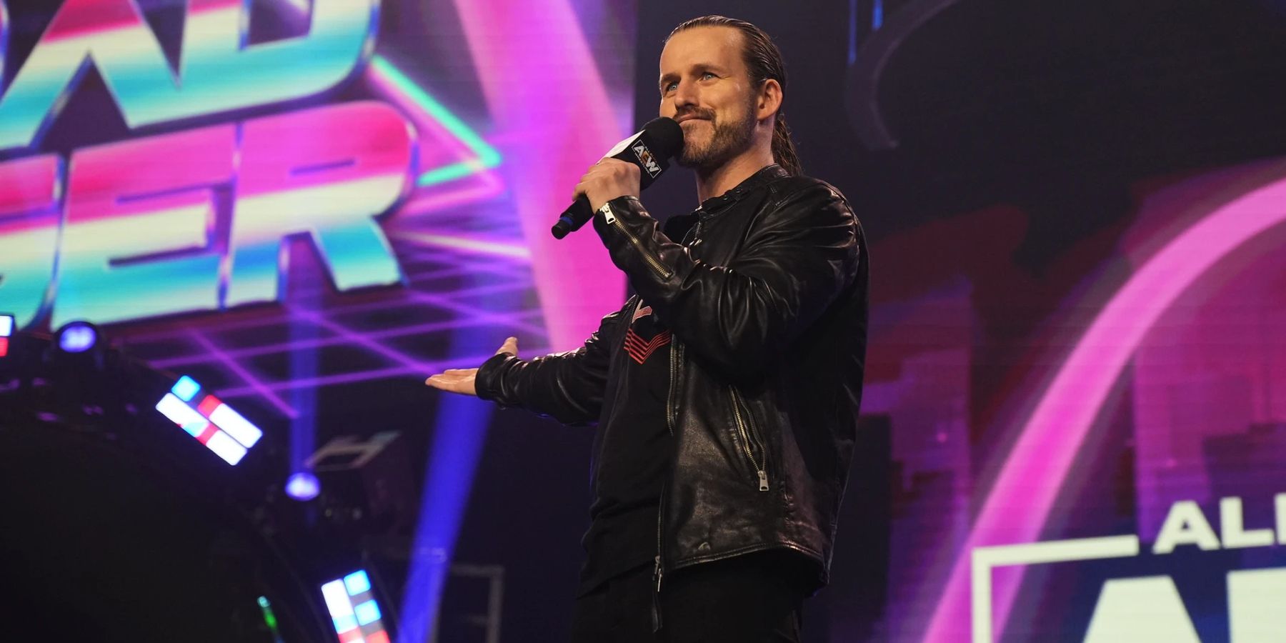 Adam Cole prepares to introduce a friend of his during AEW Road Rager in 2022.