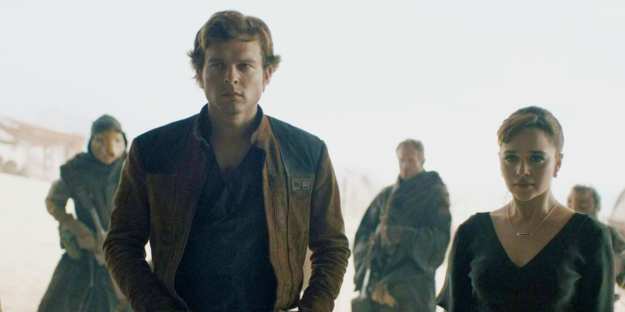 Alden Ehrenreich and Emilia Clarke standing side by side in Solo A Star Wars Story