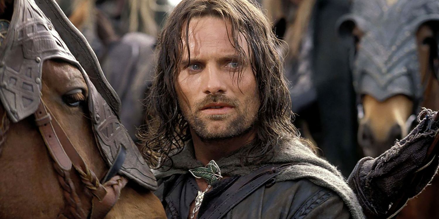 Aragorn looks on in Lord of the Rings The Two Towers while standing in front of horses.