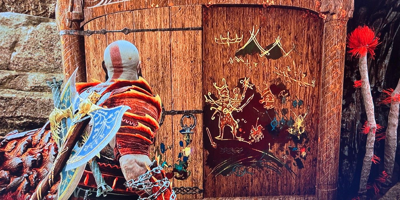 An image of Kratos looking at artwork in God of War Ragnarok