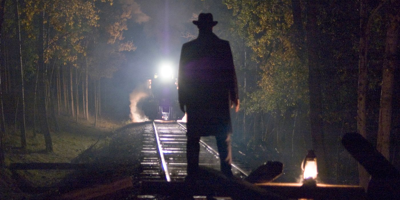 Jesse James silhouetted by the headlight of an approaching train in The Assassination of Jesse James by the Coward Robert Ford