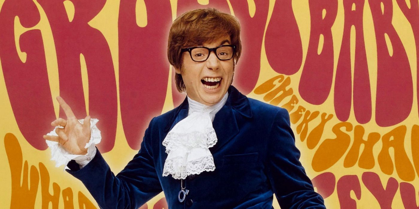 Austin Powers smiles while standing in front of a colorful background 
