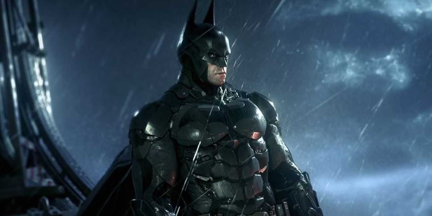 A screenshot of Batman standing in the rain during Batman: Arkham Knight.
