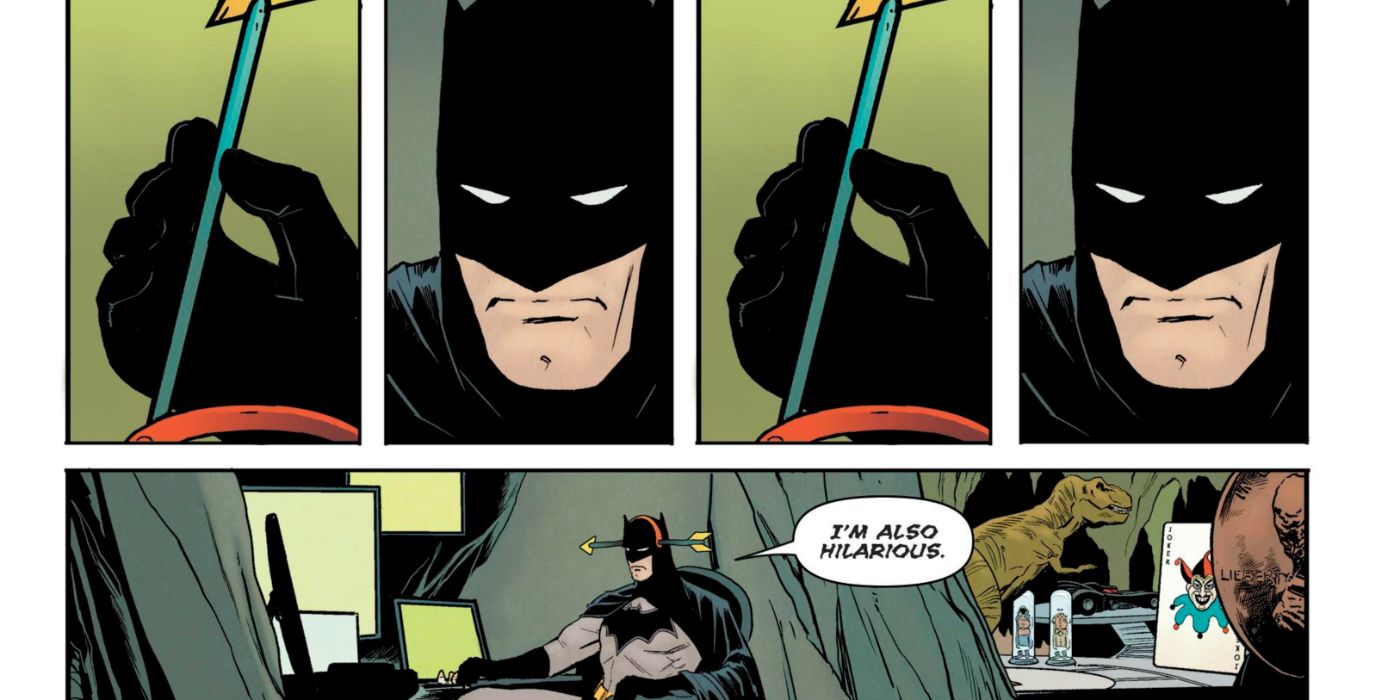 Batman wearing a fake arrow on his head while sitting in his chair in the Batcave.