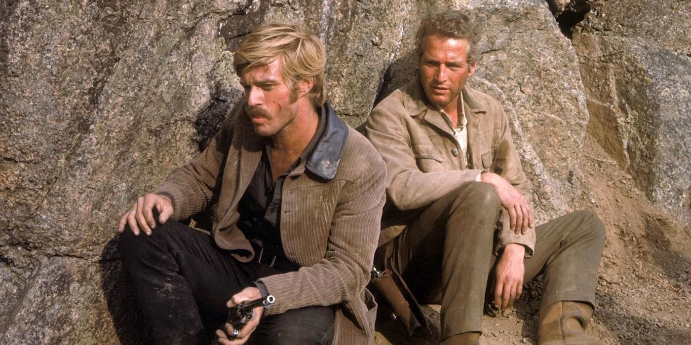 Paul Newman's Butch Cassidy and Robert Redford's Sundance Kid take refuge behind huge rocks in the mountains in Butch Cassidy and the Sundance Kid