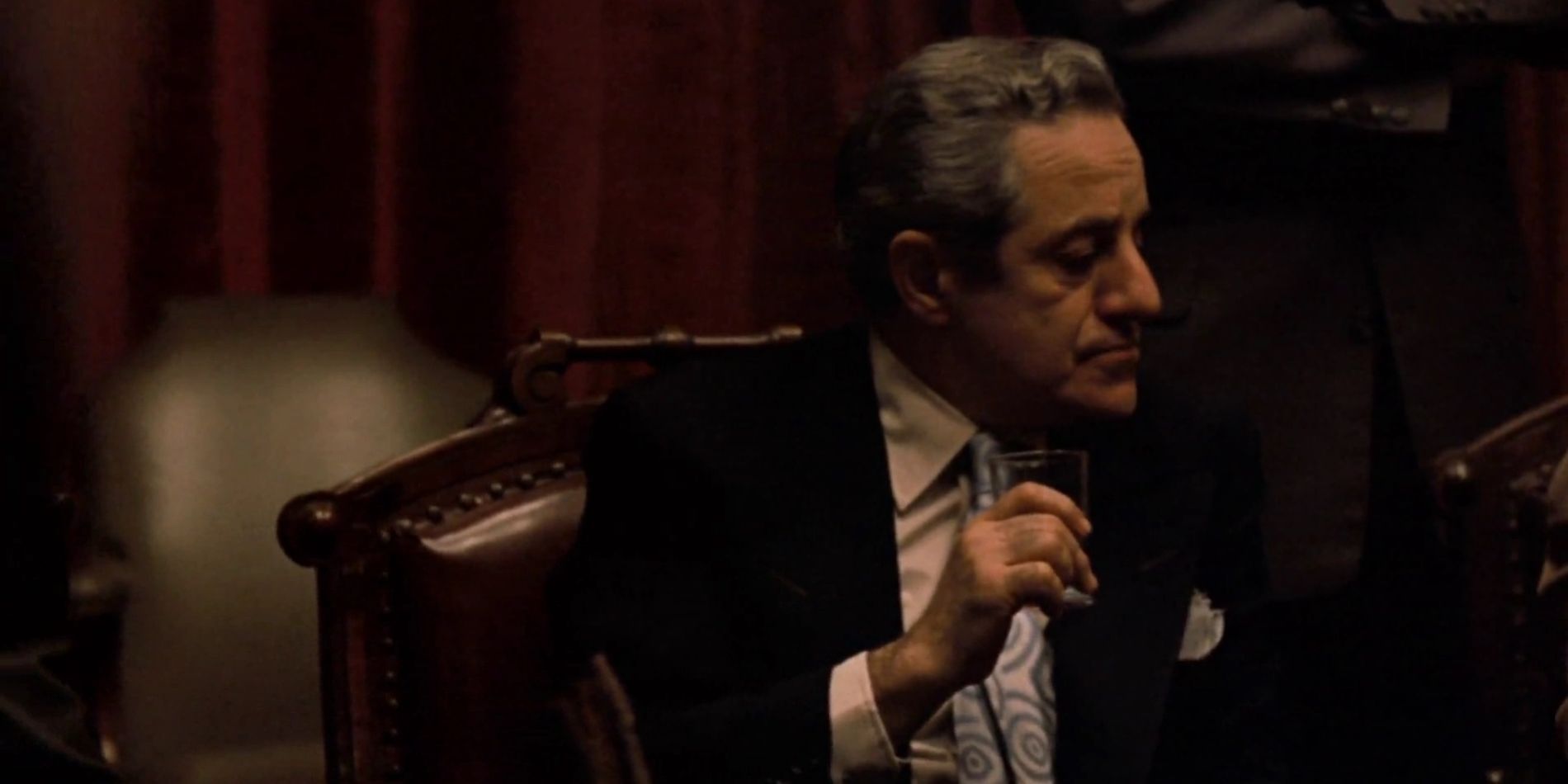 Carmine Cuneo sentado em O Poderoso Chefão.