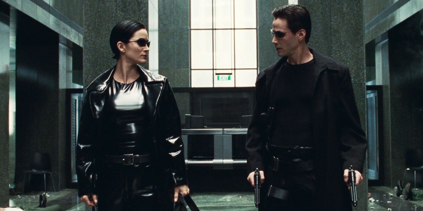 Carrie Anne Moss as Trinity and Keanu Reeves as Neo looking at each other in The Matrix