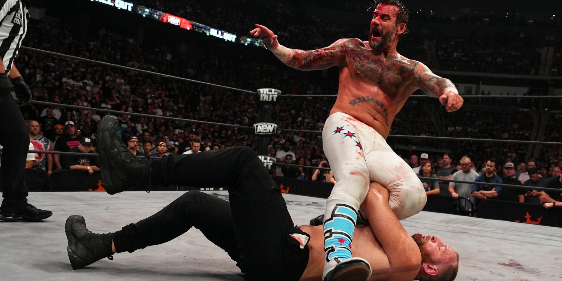 CM Punk gets rolled up by Jon Moxley during their match at AEW All Out in 2022.