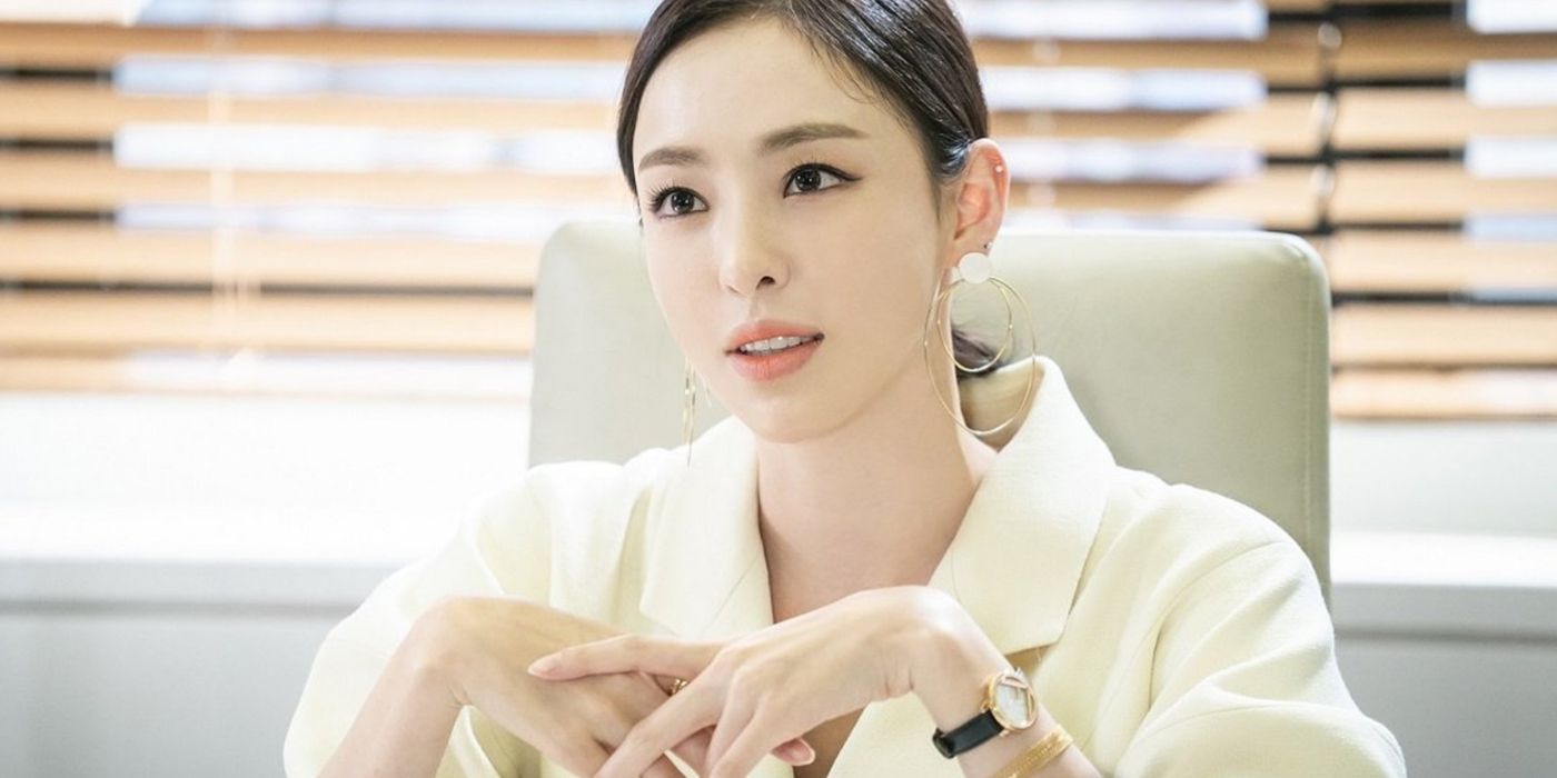 Lee Da-hee sitting with hands crossed at a desk