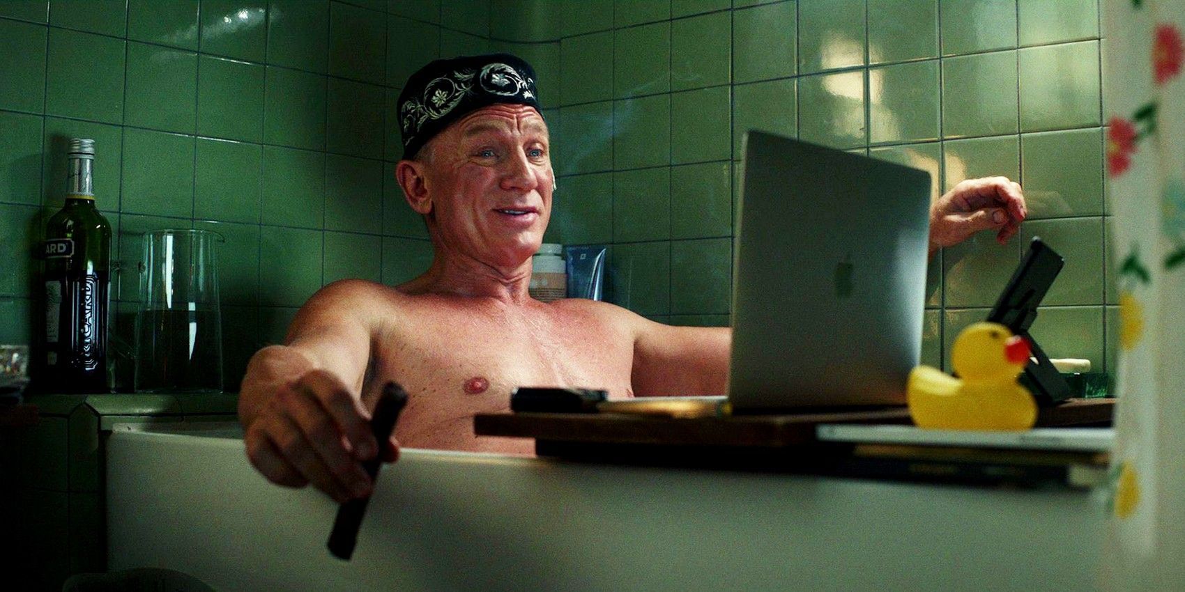 Daniel Craig as Benoit Blanc sitting in the bathtub in Glass Onion