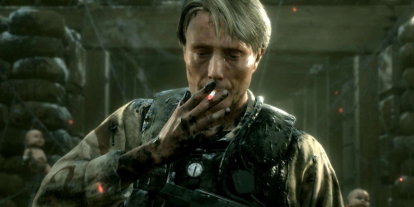 Screenshot of Mads Mikkelsen's character from Death Stranding in tactical body armor smoking a cigarette.