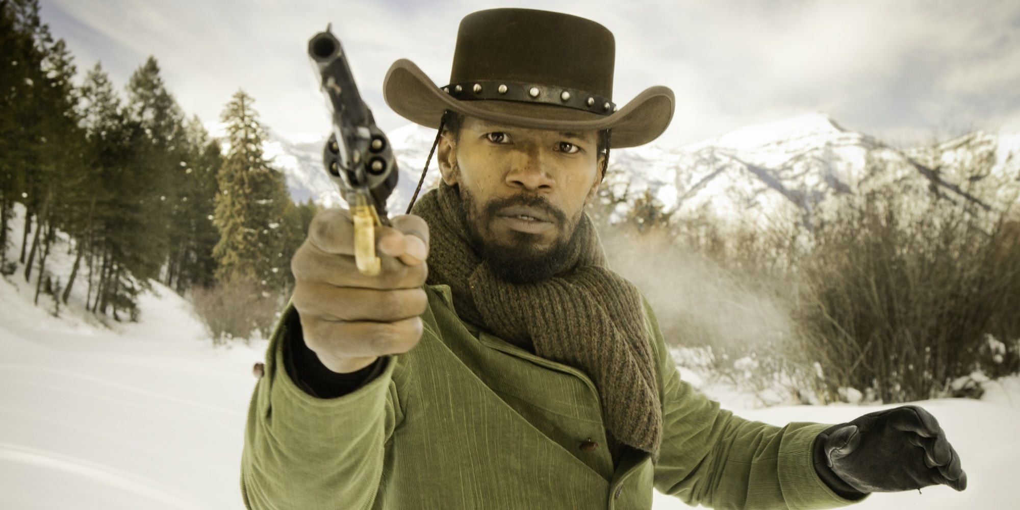 Django (Jamie Foxx) shooting a pistol in the snow in Django Unchained.