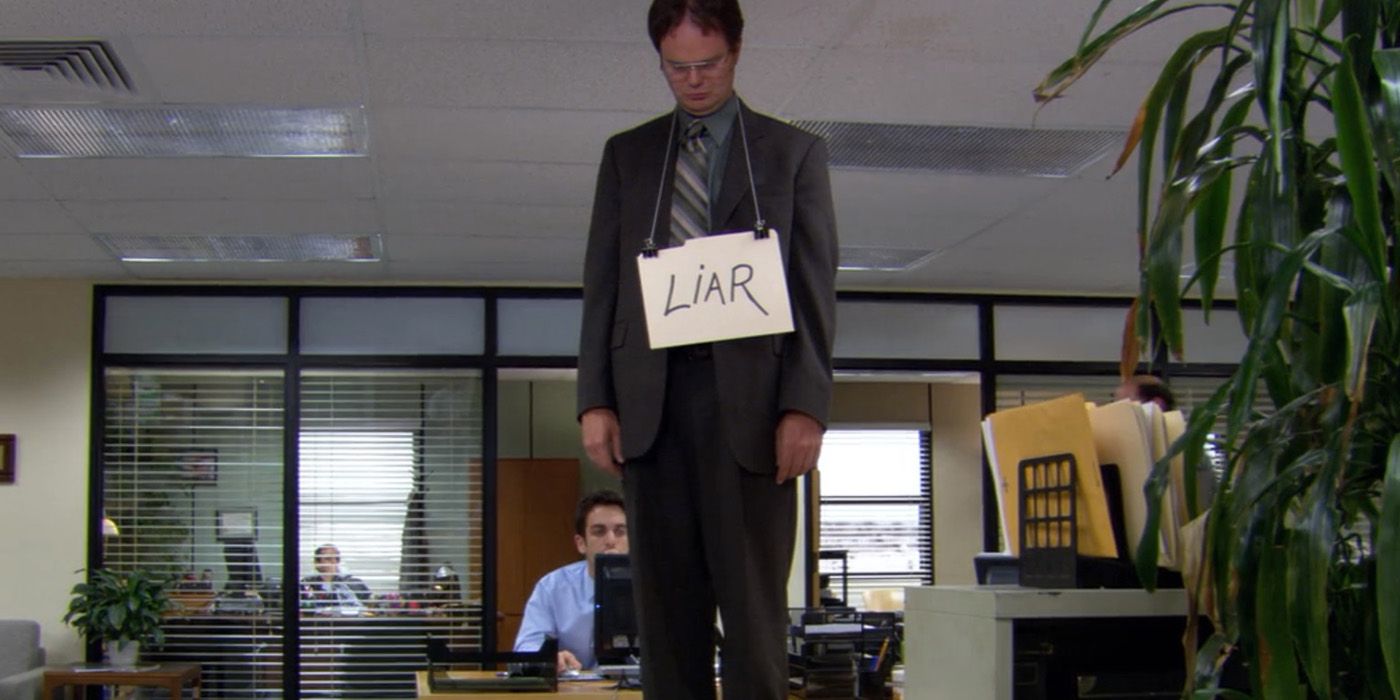 Dwight (Rainn Wilson) wearing a liar sign after his betrayal of Michael in The Office