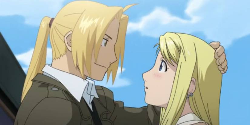 Edward holds Winry's head as the two look at each other in Fullmetal Alchemist.
