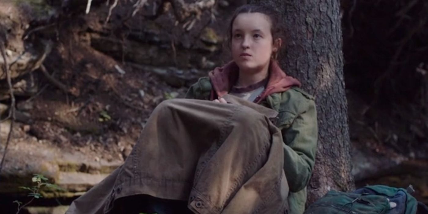 Ellie sitting against a tree in the woods in Last of Us Episode 3