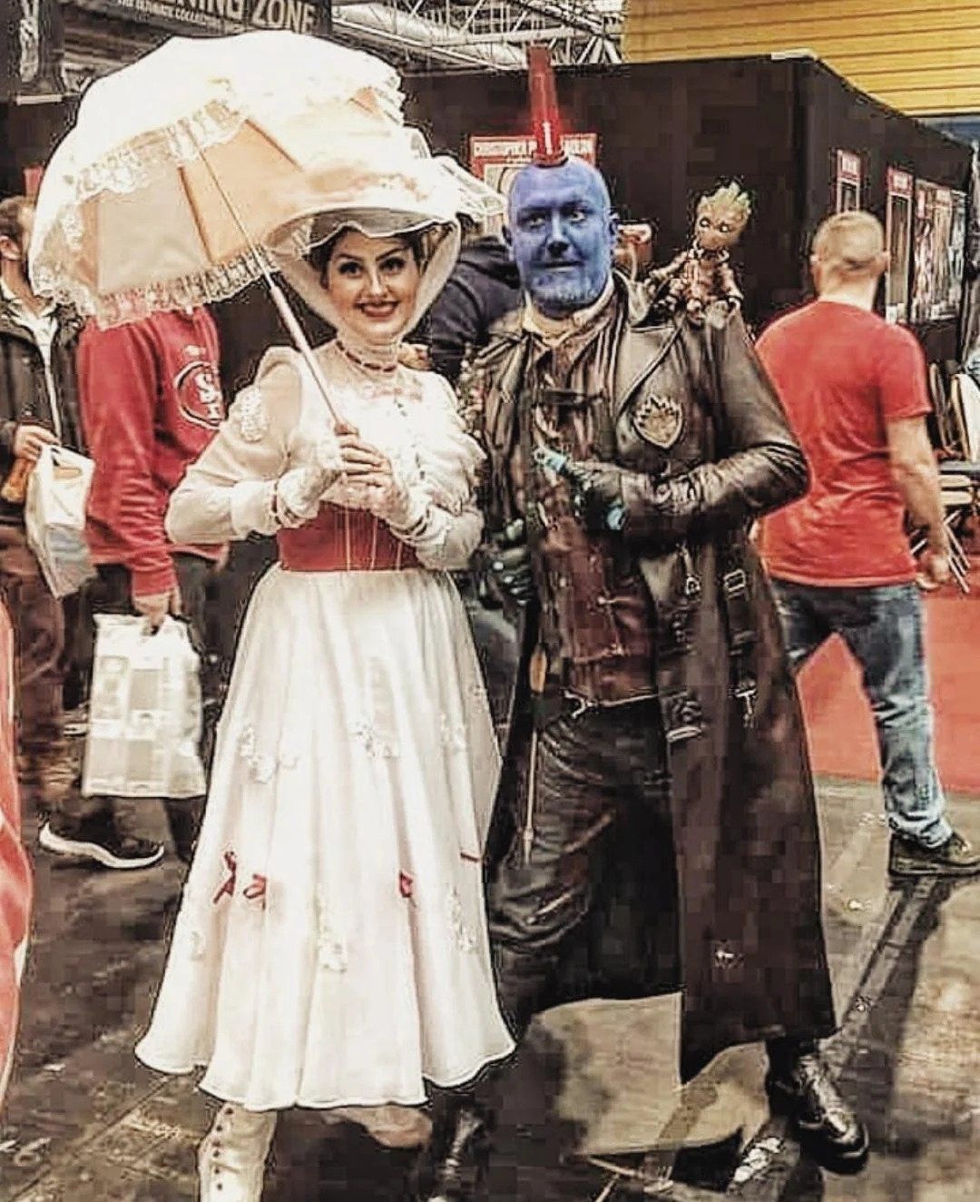 A cosplay of Mary Poppins smiling and taking a photo with Yondu from Guardians of the Galaxy