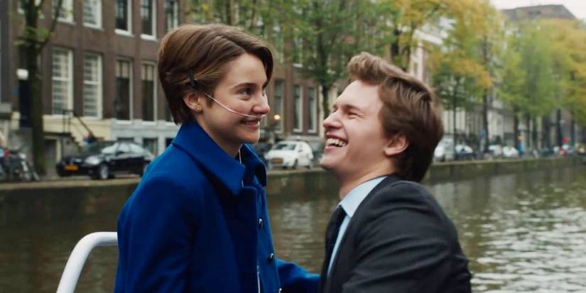 Hazel and Gus smiling by the water in Amsterdam in The Fault In Our Stars