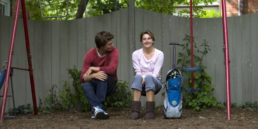 Hazel and Gus sitting outside with an oxygen tank in The Fault In Our Stars
