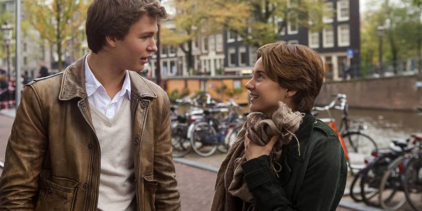 Gus and Hazel smiling at each other in Amsterdam in The Fault In Our Stars