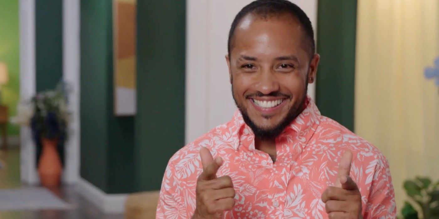 Gabriel Paboga In 90 Day Fiancé: The Other Way confessional wearing printed peach shirt and doing finger guns signs while smiling