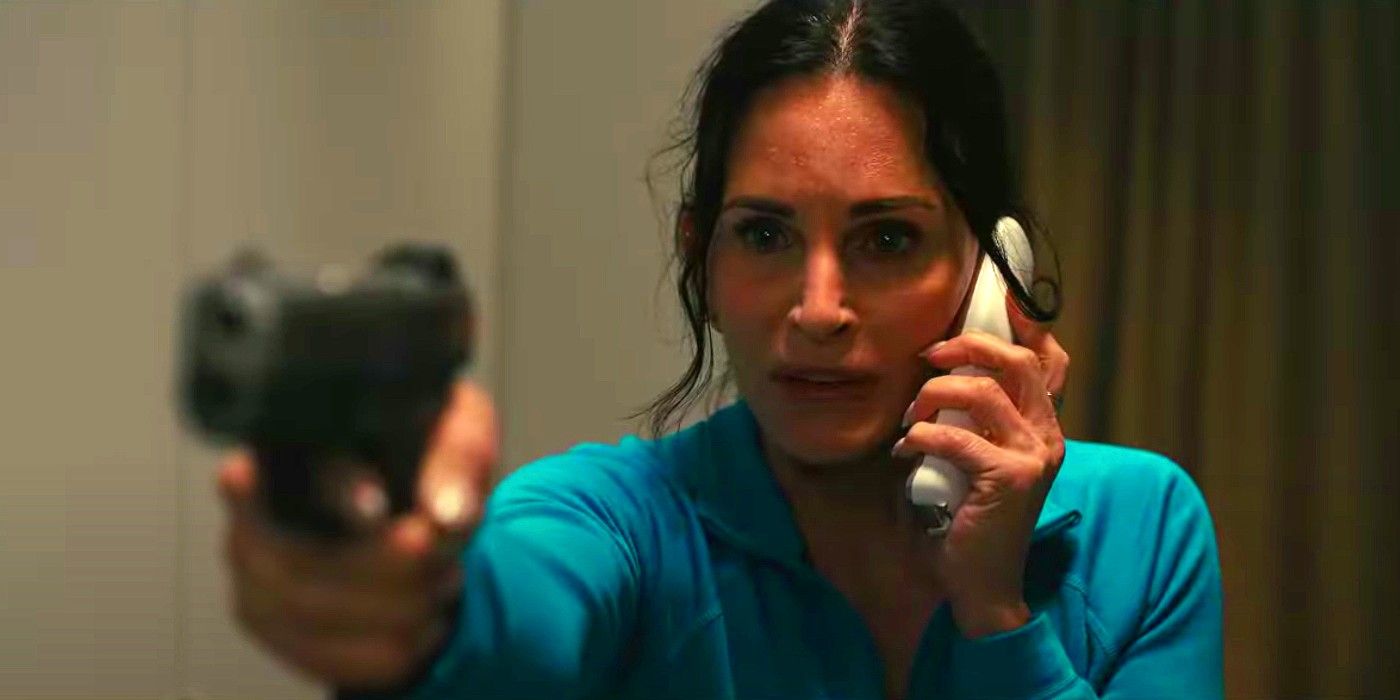 Gale holding a gun out while on the phone in Scream 6