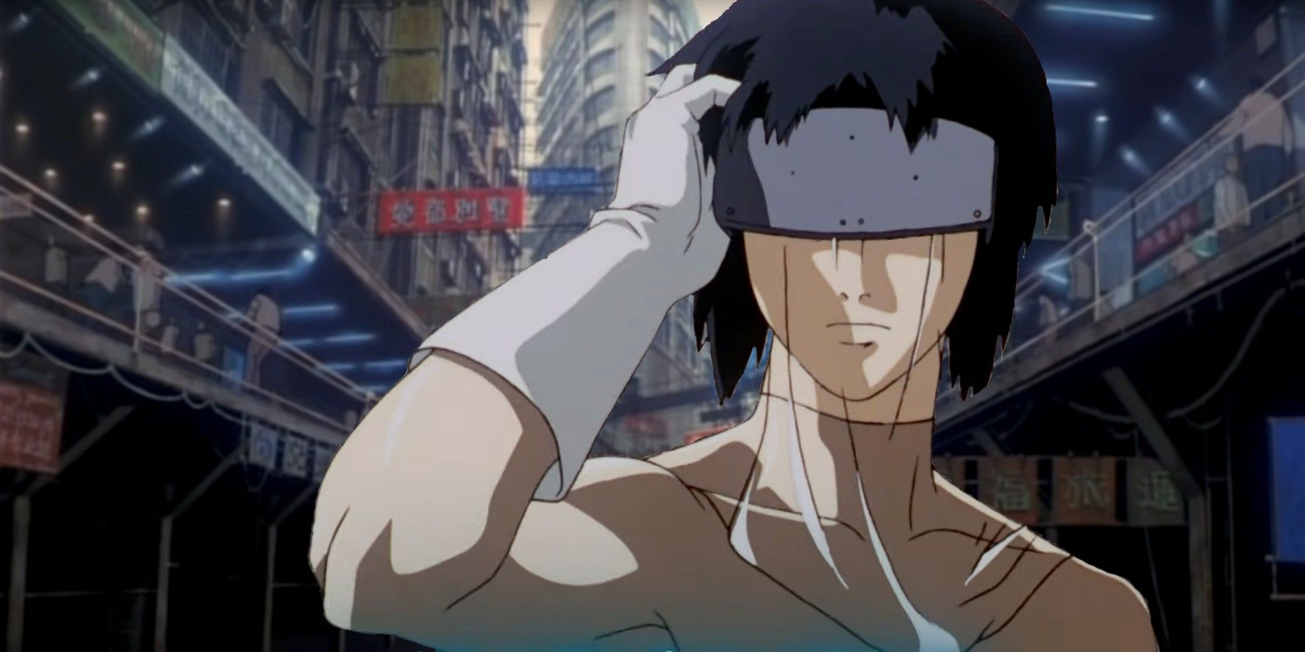 Major Motoko Kusanagi stands in a street holding a mask over her eyes in Ghost in the Shell.