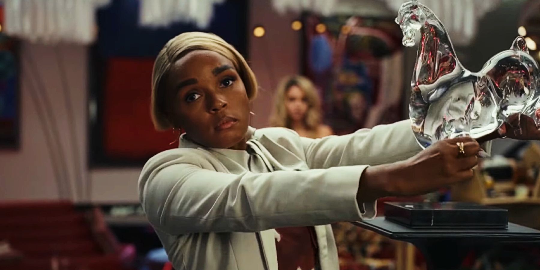 Janelle Monae about to break a glass sculpture in Glass Onion: A Knives Out Mystery.