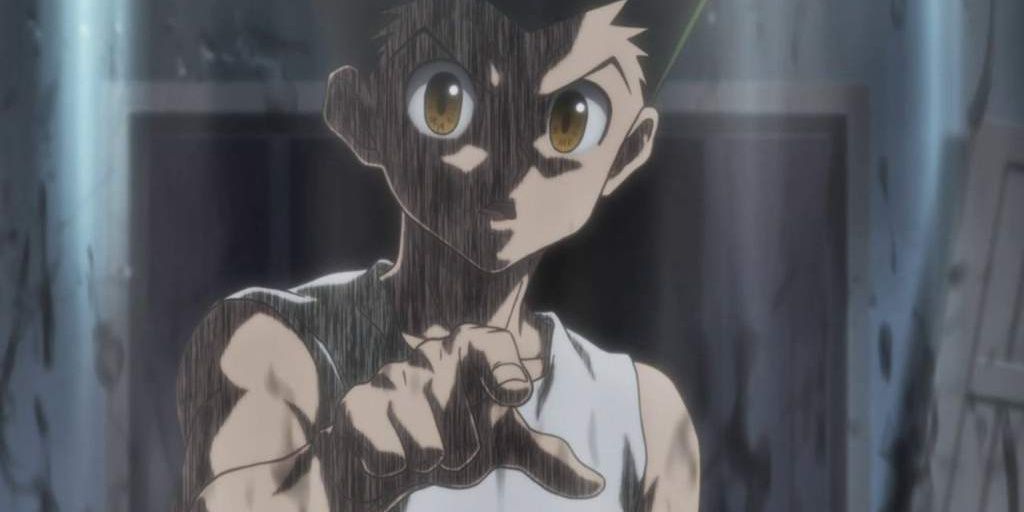 Gon Freecss pointing threateningly at the camera, surrounded by a dark aura in Hunter x Hunter.